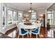 Bright dining room boasts a large round table and six chairs near large picture windows at 3300 Chancellor Ln, Monroe, NC 28110