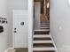 Welcoming entryway featuring a door with keys, and staircase with hardwood steps at 3300 Chancellor Ln, Monroe, NC 28110