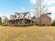 Charming brick home featuring a long, inviting porch, and a well-maintained front yard at 3300 Chancellor Ln, Monroe, NC 28110