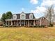 Charming brick home featuring a long, inviting porch, and a well-maintained front yard at 3300 Chancellor Ln, Monroe, NC 28110