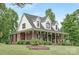 Beautiful brick home features a large porch with greenery, creating a warm and inviting entrance at 3300 Chancellor Ln, Monroe, NC 28110