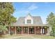 Charming brick house with a wide porch, rocking chairs, and manicured lawn at 3300 Chancellor Ln, Monroe, NC 28110