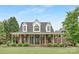 Charming brick home with a wide, covered porch and manicured landscaping, creating a welcoming curb appeal at 3300 Chancellor Ln, Monroe, NC 28110