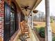 Inviting front porch with rocking chairs and black shutters, great for relaxing at 3300 Chancellor Ln, Monroe, NC 28110