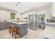 Bright, open kitchen with a large island, stainless steel appliances, and stylish pendant lighting at 3300 Chancellor Ln, Monroe, NC 28110