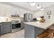 Well-appointed kitchen includes stainless steel appliances, gray cabinets, and a functional center island at 3300 Chancellor Ln, Monroe, NC 28110