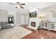Comfortable living room showcasing a white brick fireplace, hardwood floors, and modern furnishings at 3300 Chancellor Ln, Monroe, NC 28110