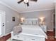 Comfortable main bedroom with a ceiling fan and a double door entry at 3300 Chancellor Ln, Monroe, NC 28110