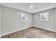 Bright bedroom with wood-look flooring and two windows at 3301 10Th Ne Ave, Conover, NC 28613