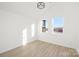 Sunlit bedroom featuring large windows offering scenic views and a modern ceiling light at 3308 Polk And White Rd, Charlotte, NC 28269