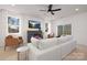 Bright living room with a modern electric fireplace, large white sofa, and plenty of natural light at 3308 Polk And White Rd, Charlotte, NC 28269