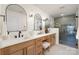 Bright bathroom features double vanities with marble counters, black hardware, and a glass enclosed shower at 3312 Polk And White Rd, Charlotte, NC 28269