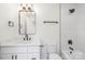 Elegant bathroom featuring a white vanity with a marble counter and a white tiled shower-tub at 3312 Polk And White Rd, Charlotte, NC 28269