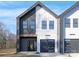 Modern townhouse exterior showcasing two-story design, black windows, and a gray garage door at 3312 Polk And White Rd, Charlotte, NC 28269