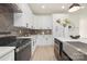 Well-lit kitchen features white cabinetry, stainless steel appliances, a herringbone backsplash, and ample counter space at 3312 Polk And White Rd, Charlotte, NC 28269