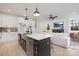 Modern kitchen with stainless steel appliances, white cabinets, and an island open to the bright living space at 3312 Polk And White Rd, Charlotte, NC 28269