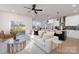 Bright, open-concept living room featuring modern furniture, a ceiling fan, and an open flow to the kitchen at 3312 Polk And White Rd, Charlotte, NC 28269