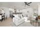 Bright, open-concept living room featuring modern furniture, a ceiling fan, and an open flow to the kitchen at 3312 Polk And White Rd, Charlotte, NC 28269