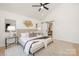 Spacious main bedroom features a ceiling fan, accent wall decor, and a sliding barn door to the en suite at 3312 Polk And White Rd, Charlotte, NC 28269