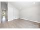 Bright bedroom with light gray walls, a large window, and sleek wood-look flooring at 338 Hudson St, Shelby, NC 28150