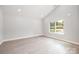 Bright bedroom with light gray walls, a large window, sleek wood-look flooring, and recessed lighting at 338 Hudson St, Shelby, NC 28150