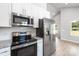 This modern kitchen is equipped with stainless steel appliances and granite countertops at 338 Hudson St, Shelby, NC 28150