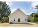 Tan sided house with white trimmed windows on a green lawn, under a sunny, blue sky at 338 Hudson St, Shelby, NC 28150