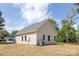 Beautiful house with tan siding, well-manicured lawn, and classic design on a sunny day at 338 Hudson St, Shelby, NC 28150