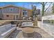 Backyard patio featuring comfortable seating arrangements, a modern outdoor fireplace, and outdoor television at 3723 Annlin Ave, Charlotte, NC 28209