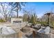 Backyard patio featuring comfortable seating arrangements, a modern outdoor fireplace, and a patio heater at 3723 Annlin Ave, Charlotte, NC 28209