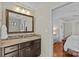 Bathroom featuring a dark wood vanity with a neutral countertop and decorative backsplash at 3723 Annlin Ave, Charlotte, NC 28209