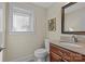 Cozy bathroom with tiled floors, framed mirror, and a window bringing in natural light at 3723 Annlin Ave, Charlotte, NC 28209