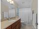 Bathroom featuring a neutral-colored vanity, a white toilet, and a shower with a striped curtain at 3723 Annlin Ave, Charlotte, NC 28209