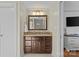 Bathroom featuring a dark wood vanity with a neutral countertop and decorative backsplash at 3723 Annlin Ave, Charlotte, NC 28209