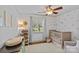 Bedroom featuring a crib, a changing table, a window with natural light, and pink polka dot wallpaper at 3723 Annlin Ave, Charlotte, NC 28209