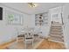 Bright dining area features a white round table, stylish chairs, and built-in shelving for a cozy and modern aesthetic at 3723 Annlin Ave, Charlotte, NC 28209