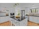 Well-appointed kitchen island with modern stools, black countertops, and stainless steel appliances in a bright, functional space at 3723 Annlin Ave, Charlotte, NC 28209