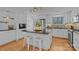 Stylish kitchen island with black countertop and white cabinets, complemented by modern stools and stainless steel appliances at 3723 Annlin Ave, Charlotte, NC 28209