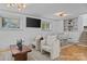 Comfortable seating area with stylish chairs, a wooden coffee table, and a blend of natural light and modern fixtures at 3723 Annlin Ave, Charlotte, NC 28209