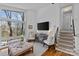 Bright living room featuring stairs, a media center, and large windows at 3723 Annlin Ave, Charlotte, NC 28209