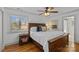 Comfortable bedroom featuring a wooden bed frame, hardwood floors, and a ceiling fan at 3723 Annlin Ave, Charlotte, NC 28209