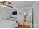 Bedroom featuring hardwood floors, a mounted television, and direct access to an adjacent room at 3723 Annlin Ave, Charlotte, NC 28209