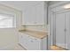 Pantry area with upper and lower cabinets, plenty of counter space, and a window for natural light at 3723 Annlin Ave, Charlotte, NC 28209