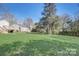 Large grassy backyard with mature trees and a deck at 3920 Admiral Ave, Charlotte, NC 28205