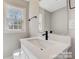 Modern bathroom with white vanity and black fixtures at 3920 Admiral Ave, Charlotte, NC 28205