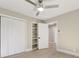 Bedroom with double doors, built-in shelving, and ceiling fan at 3920 Admiral Ave, Charlotte, NC 28205