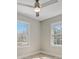 Bright bedroom with ceiling fan and two large windows at 3920 Admiral Ave, Charlotte, NC 28205