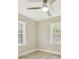 Bright bedroom with ceiling fan and two large windows at 3920 Admiral Ave, Charlotte, NC 28205