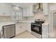 Modern kitchen with white cabinets, stainless steel appliances, and quartz countertops at 3920 Admiral Ave, Charlotte, NC 28205