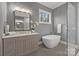 Light-filled bathroom features a soaking tub and glass shower next to light wood vanity at 3945 Ostler Ct, Lancaster, SC 29720